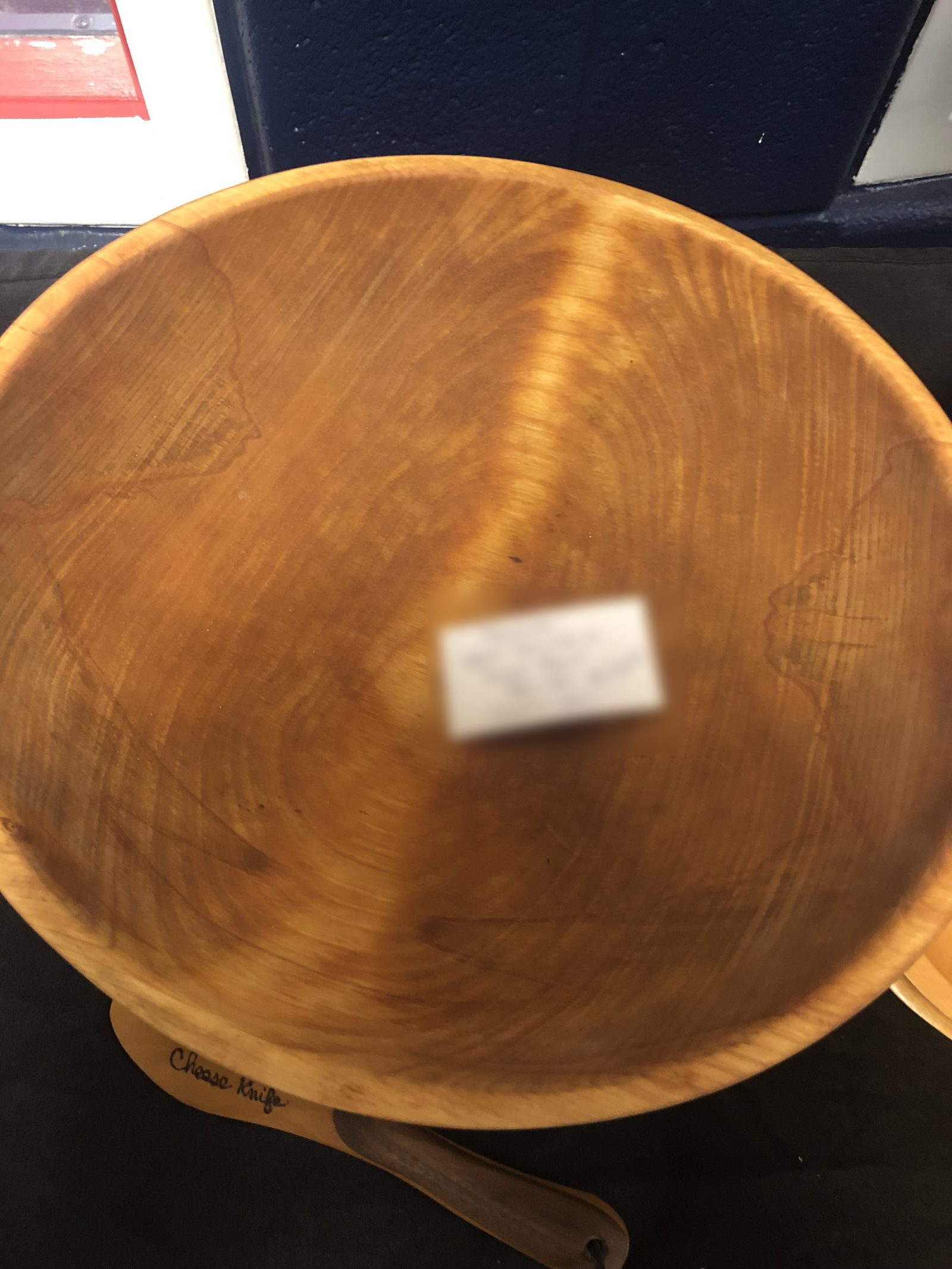 A restored Upper Peninsula dough bowl in figured maple, with a handwritten card resting in it
